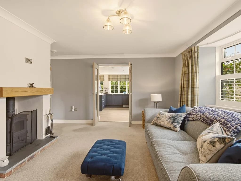 Spacious living room with wood-burning stove and open plan access to the kitchen