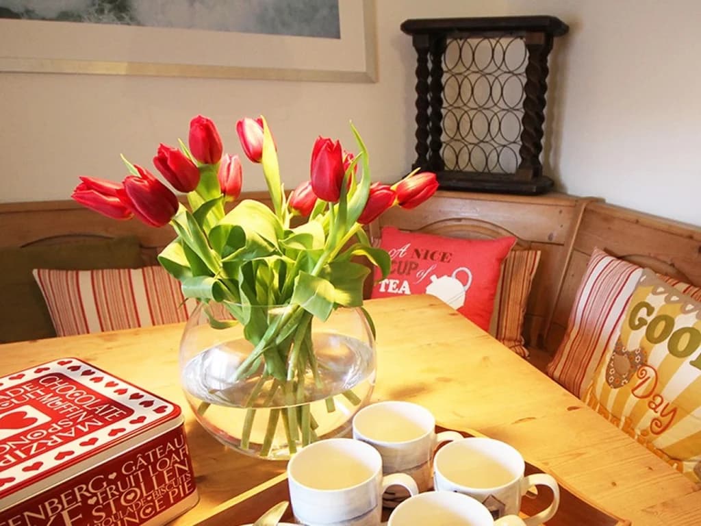 Cosy dining nook with bench seating and charming decorative touches.