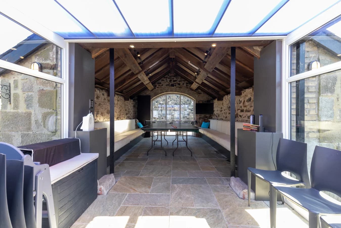 Gathering Place games room with exposed stone and timber beams