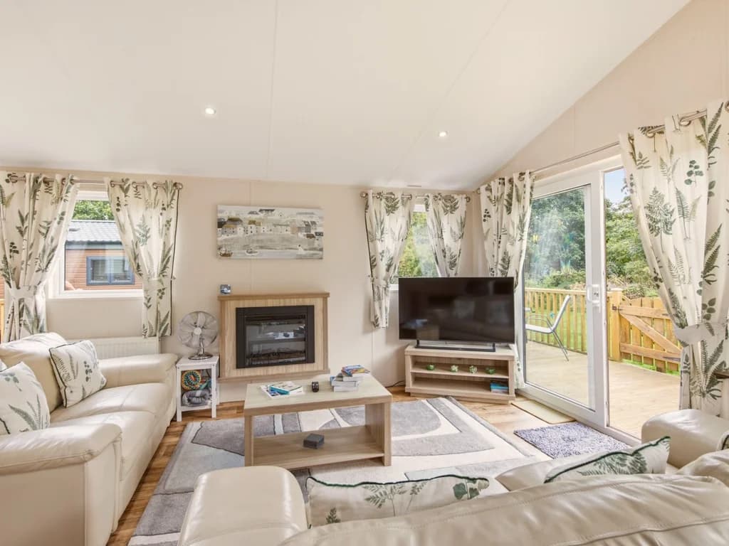 Bright living area with comfortable seating and access to the deck