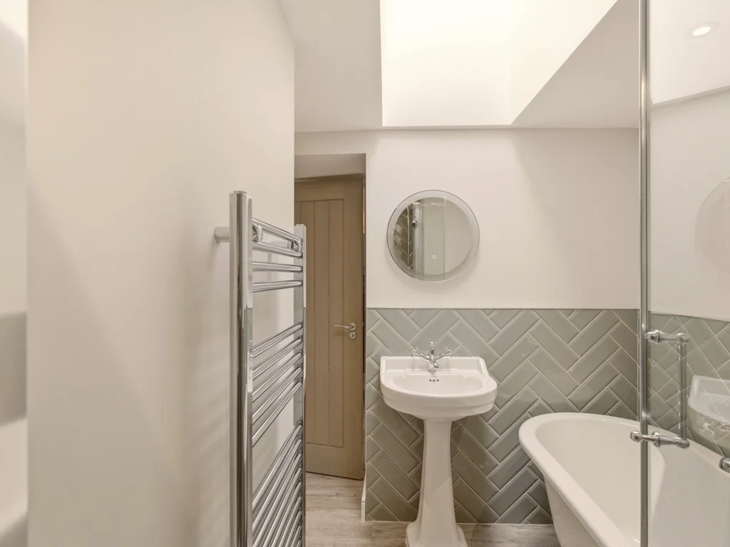Modern family bathroom with freestanding bath, chrome fittings and walk-in shower