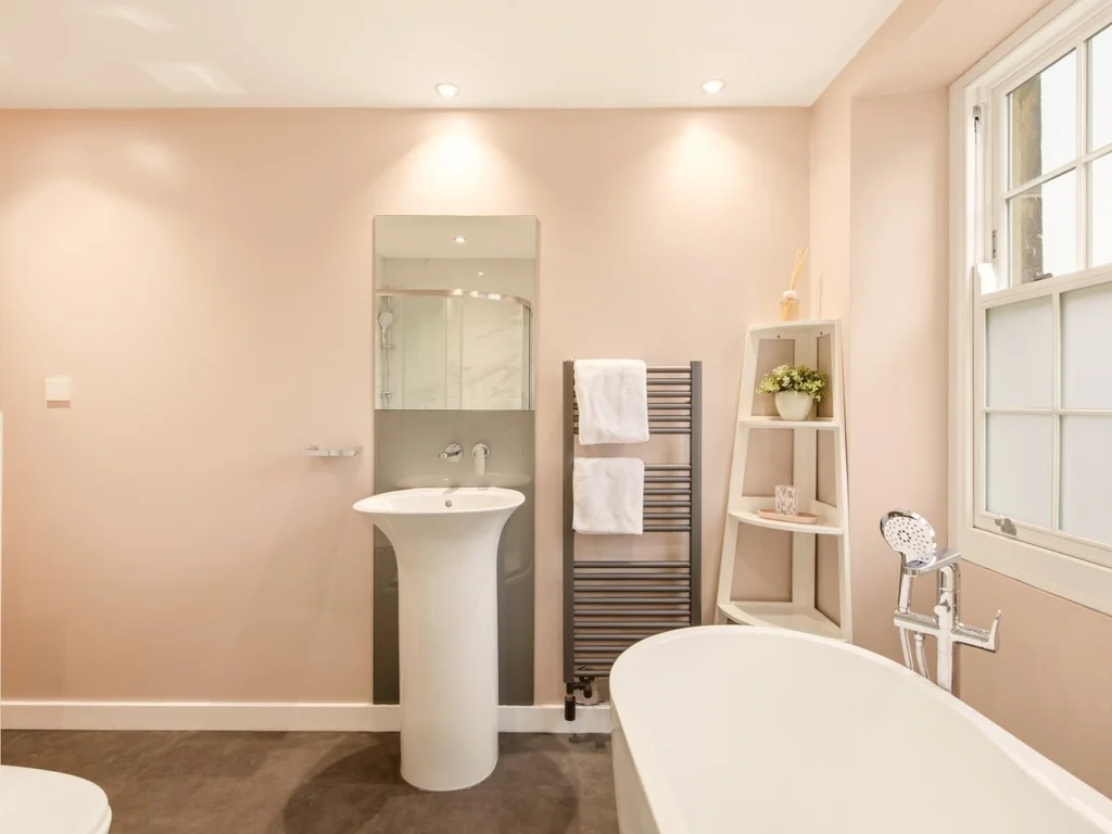 Modern family bathroom featuring a freestanding bath, walk-in shower and elegant finishes.