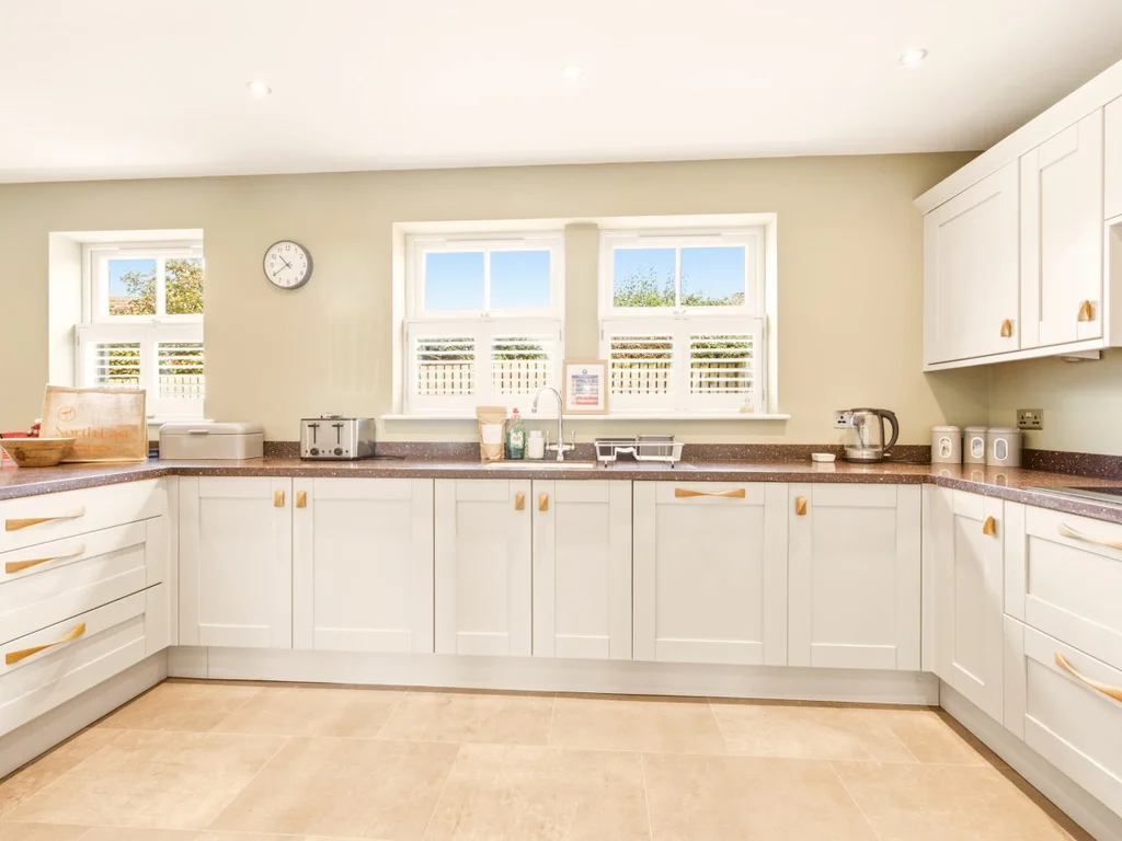 Contemporary kitchen with white cabinetry and generous worktop space