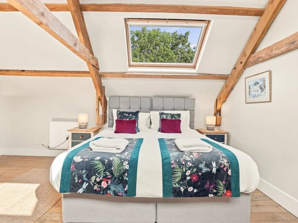 Super king bedroom with skylight and exposed timber beams