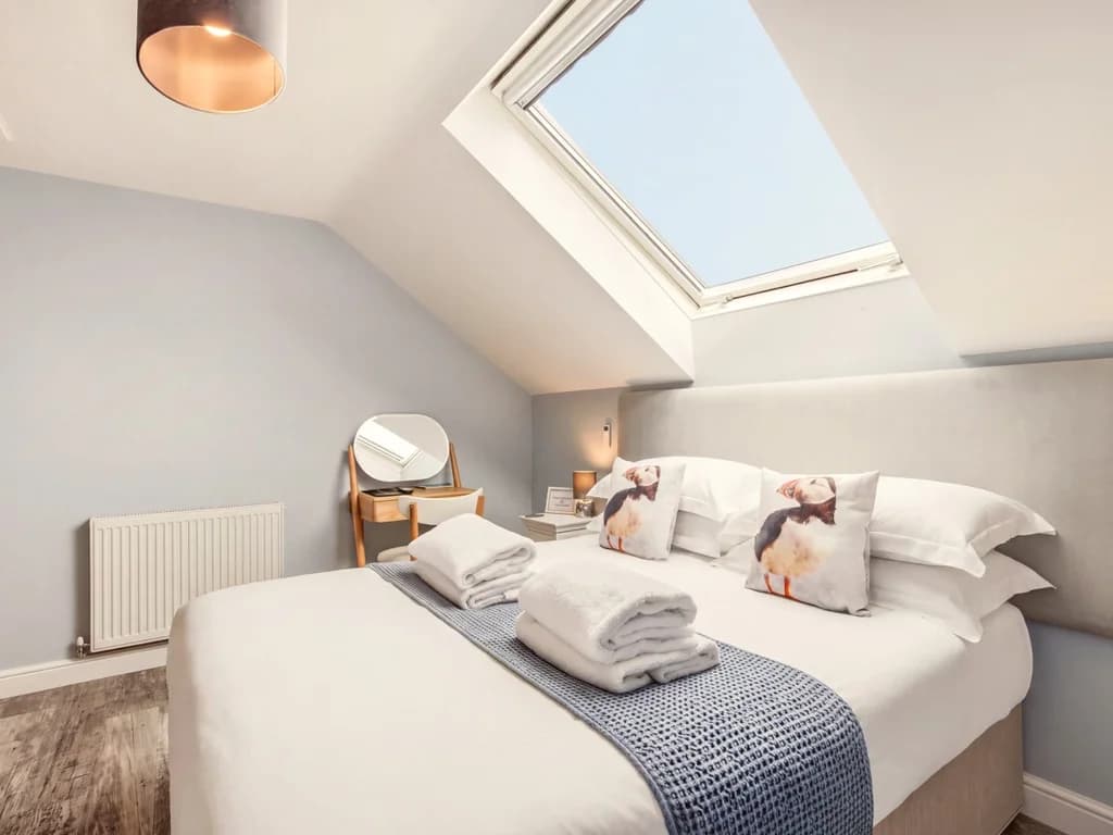 King-size bedroom with skylight, dressing area and soft furnishings