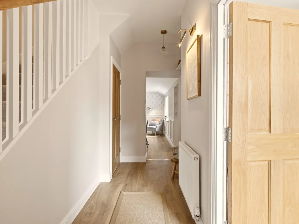 Bright entrance hallway with staircase and wood-effect flooring