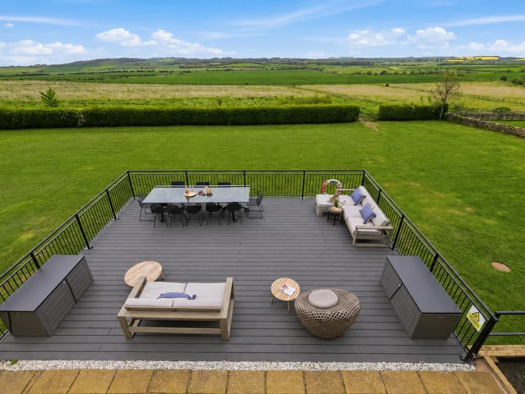 Private raised deck with lounge furniture and rolling Northumberland views.