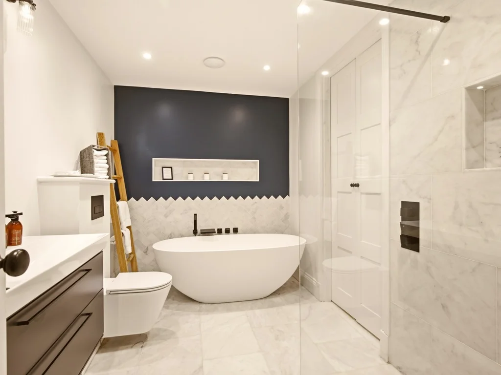 Luxurious en-suite bathroom with freestanding bath and walk-in rainfall shower