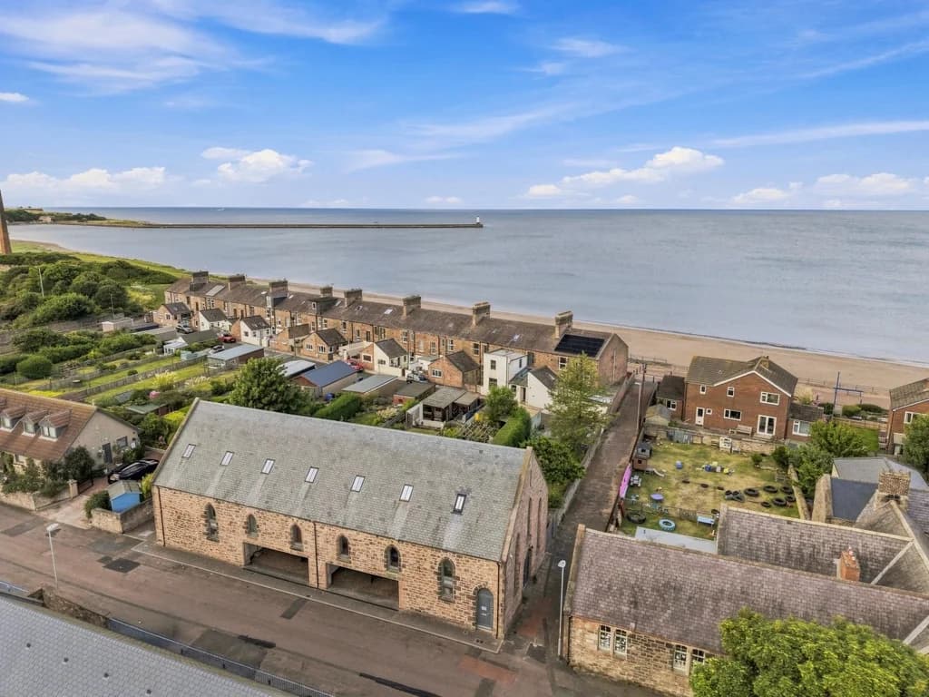 Elevated view of Old Templars Hall beside Spittal Beach and promenade.
