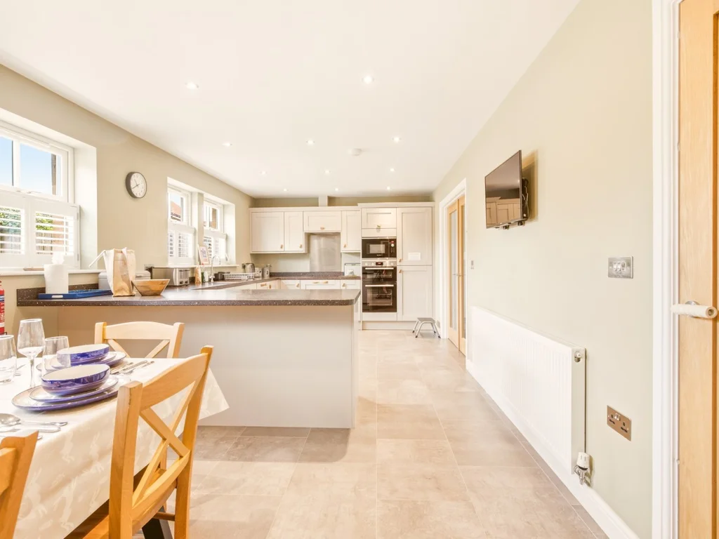 Open-plan kitchen and dining area with seating for six guests