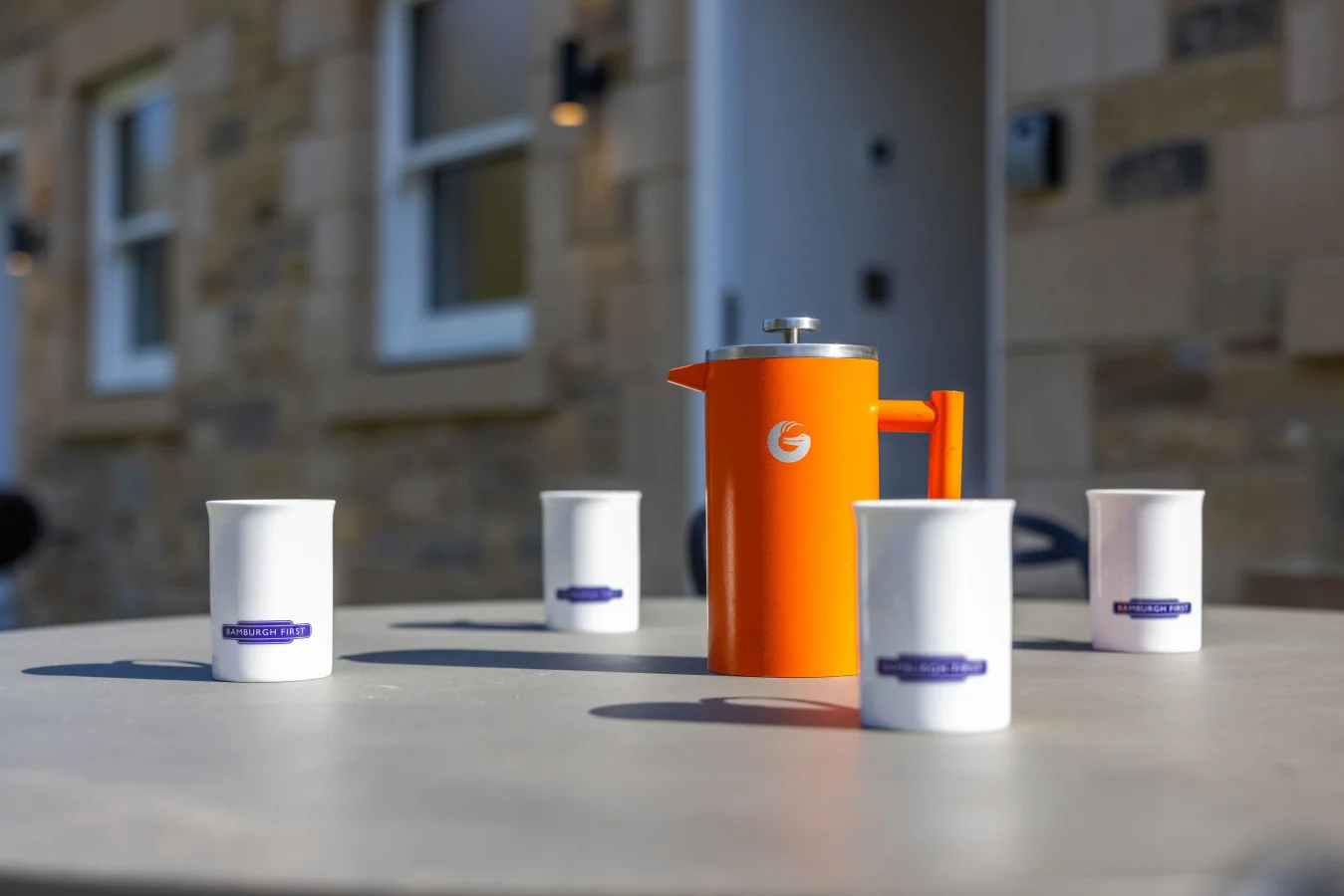 Outdoor dining table with Bamburgh First branding