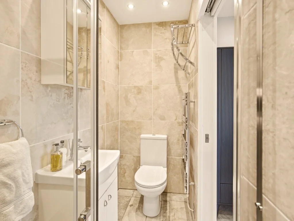 Comfortable ensuite with walk in shower and modern furnishings