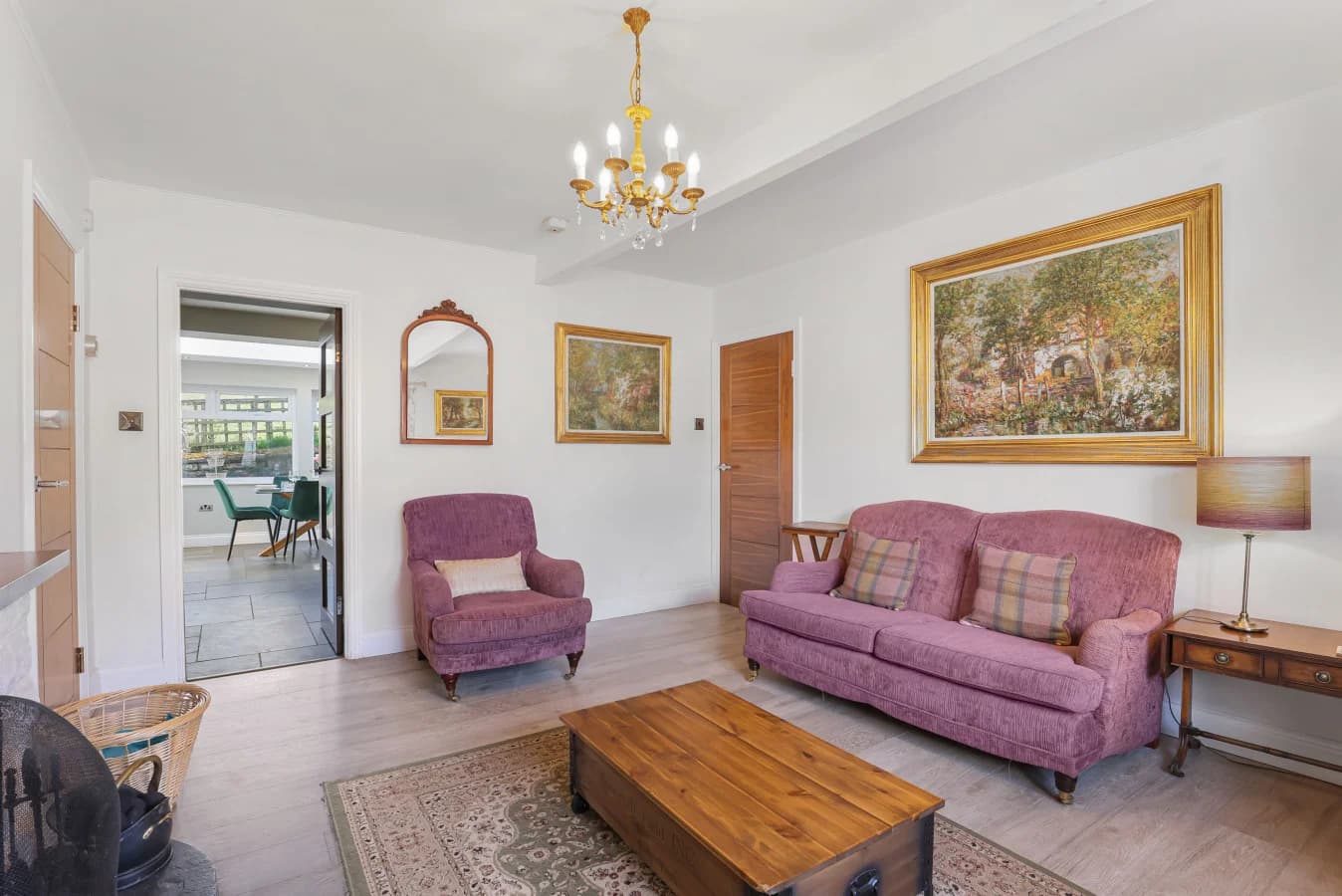 Comfortable sitting room with mauve sofas and garden views
