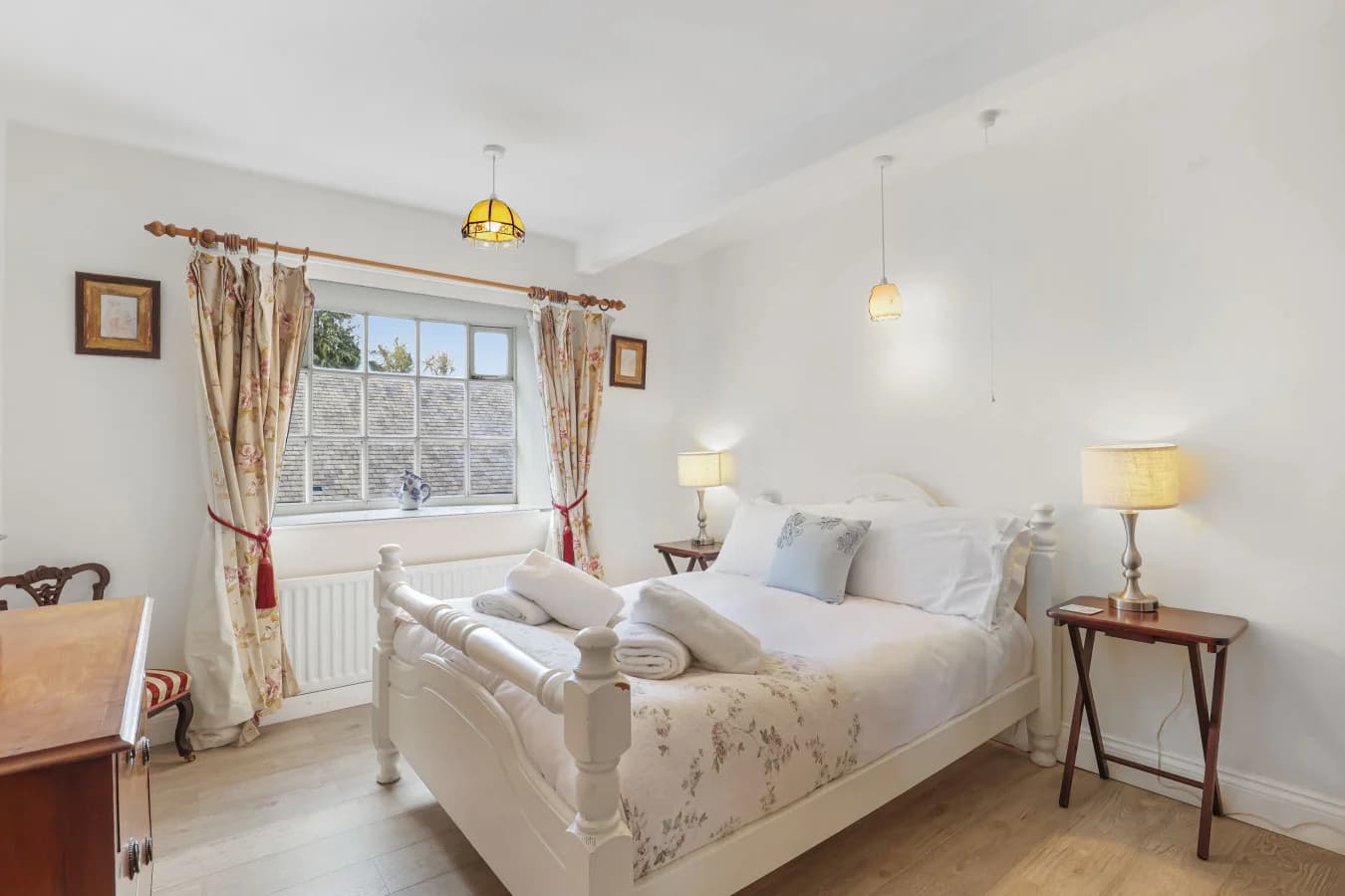 Double bedroom with garden views and cream-painted