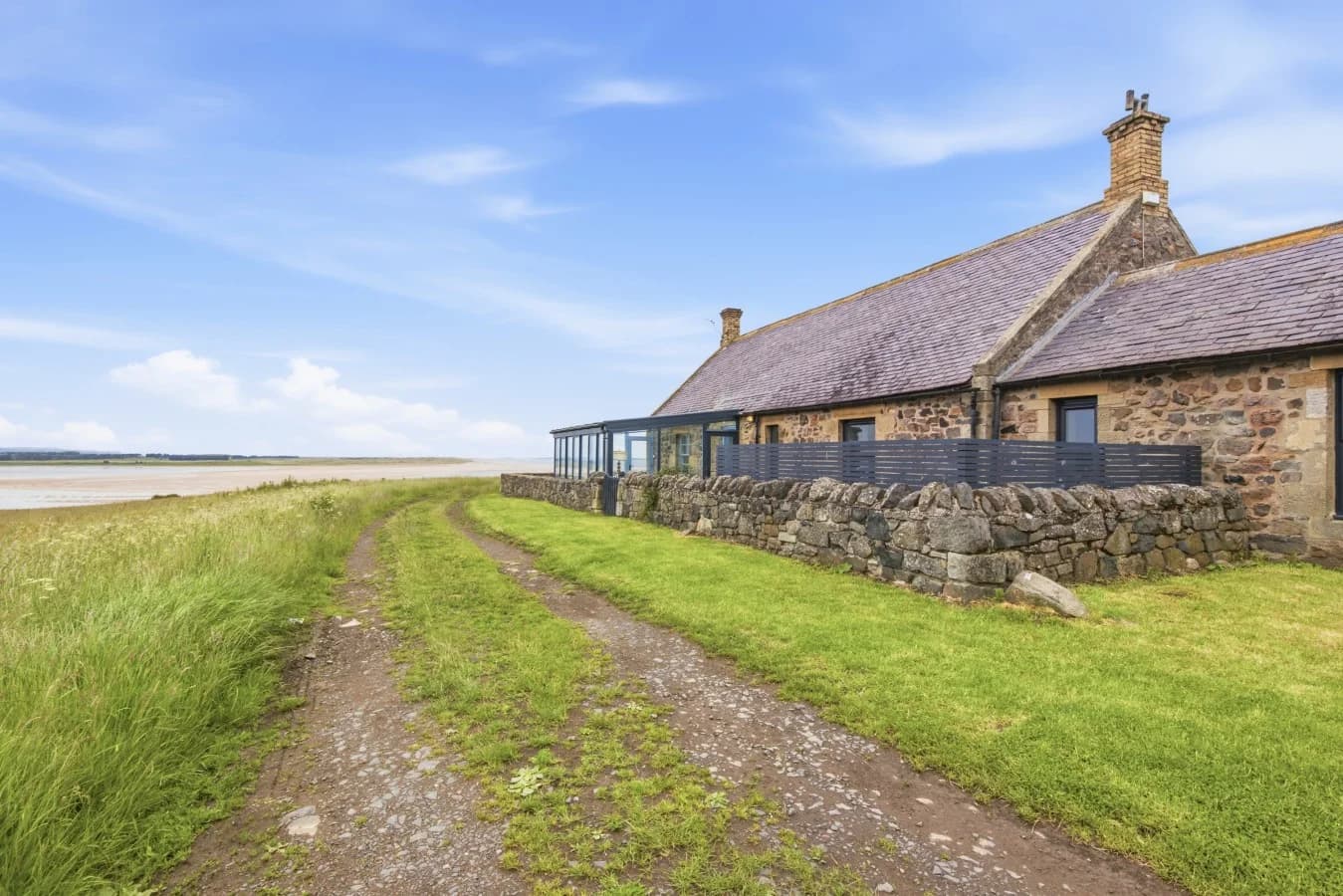 Stone cottage with enclosed garden overlooking Budle Bay