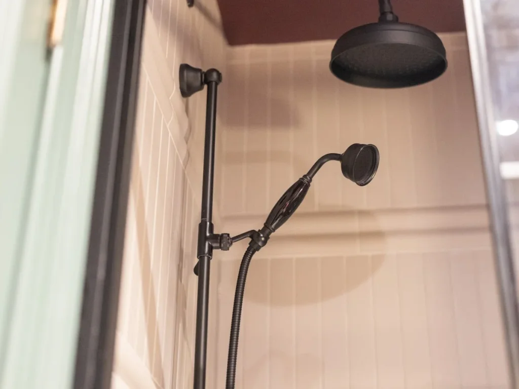 Walk-in shower with rainfall and handheld shower fittings.