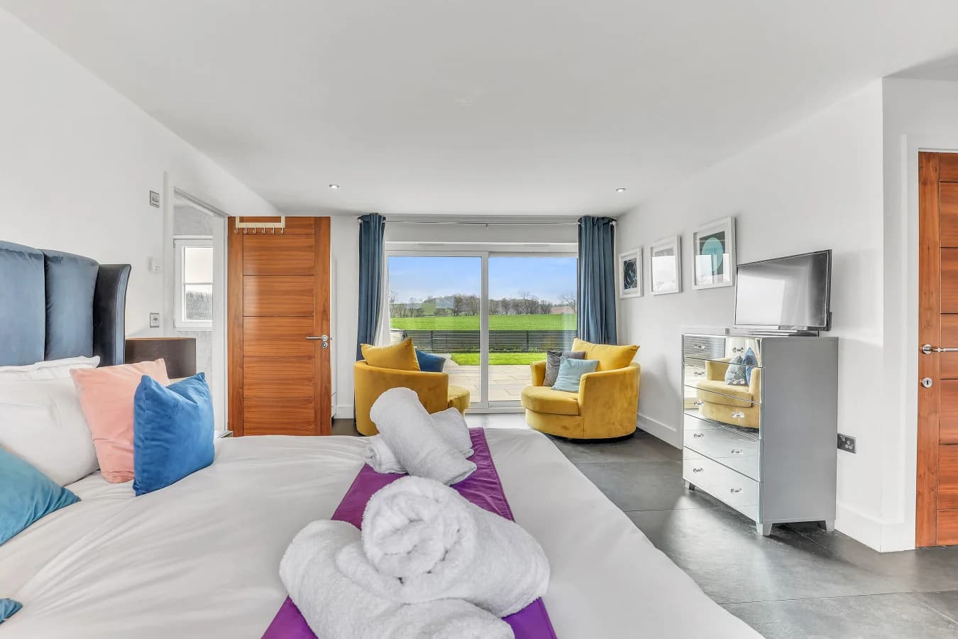 Spacious bedroom with countryside views and seating area