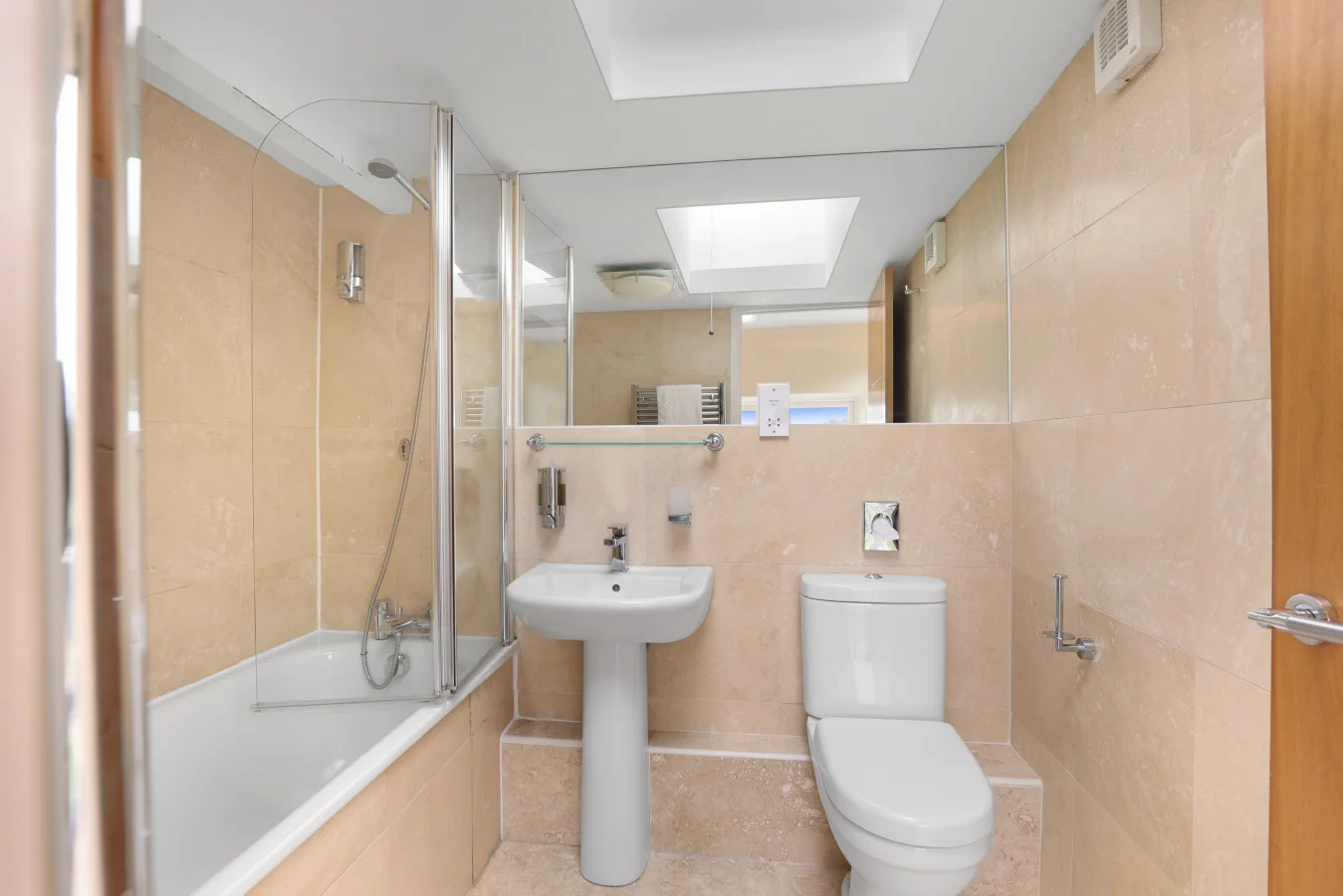 Bathroom with bath, shower, and skylight