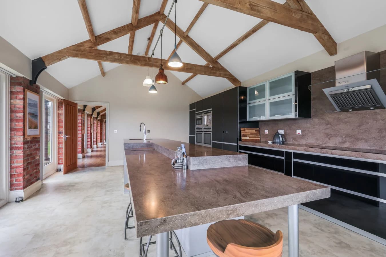 Stylish kitchen with breakfast bar and exposed brick details