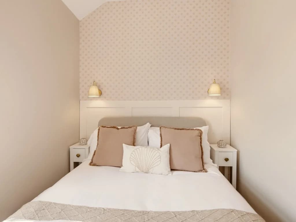 Double bedroom with patterned feature wall and bedside tables