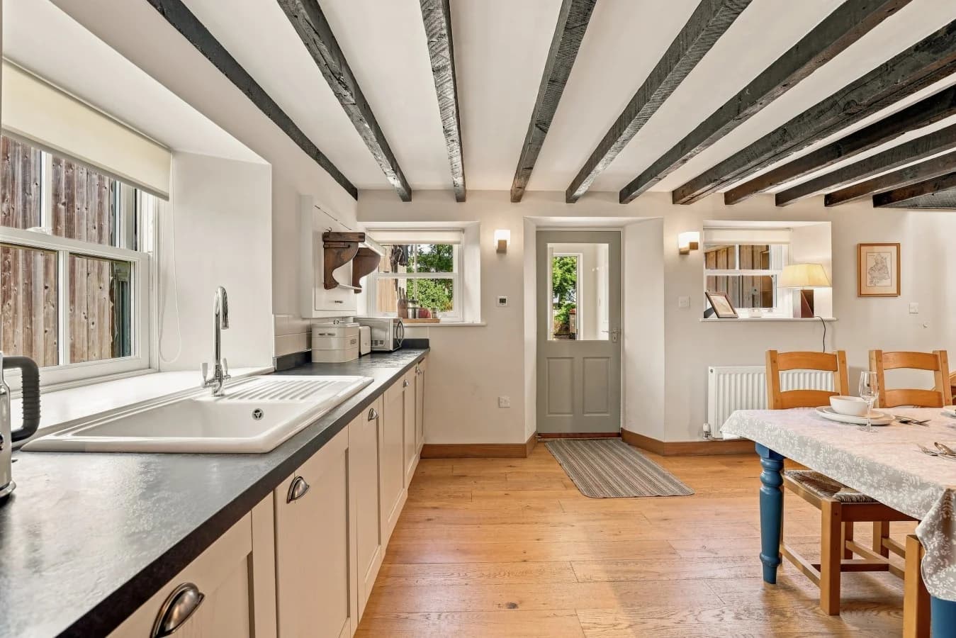 Kitchen workspace with farmhouse sink beside the dining area