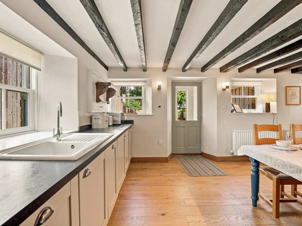 Kitchen workspace with farmhouse sink beside the dining area