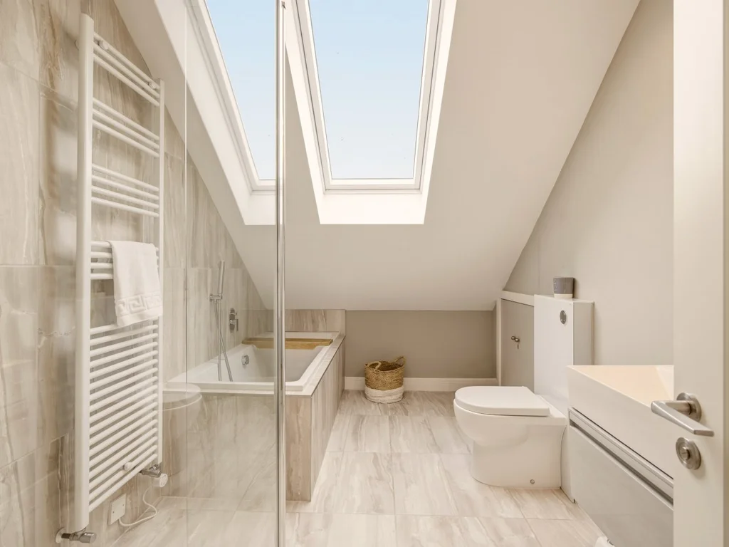 Family bathroom with bath, walk-in shower and twin skylights