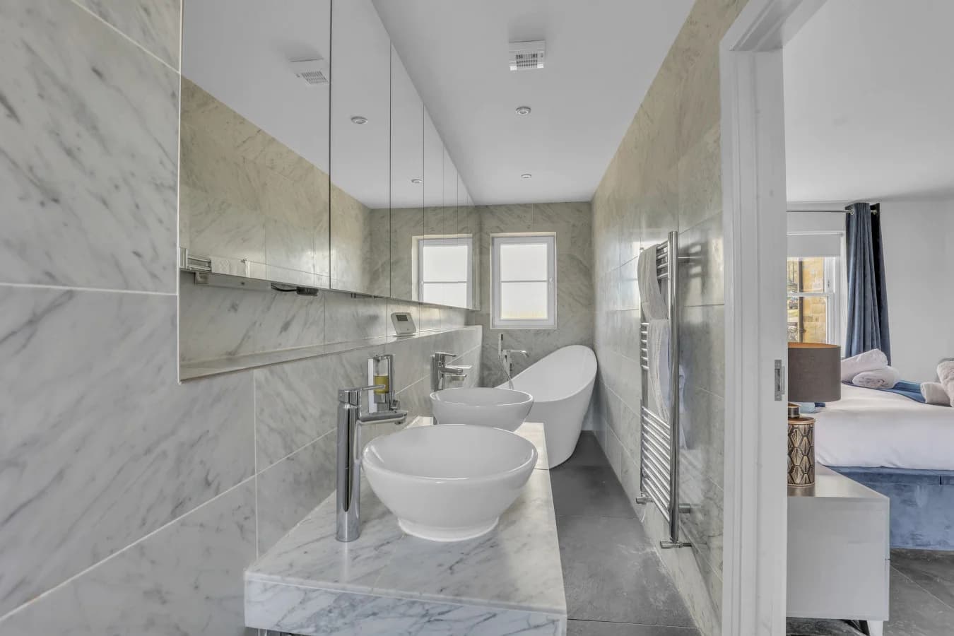 Stylish ensuite with freestanding bath and marble finishes