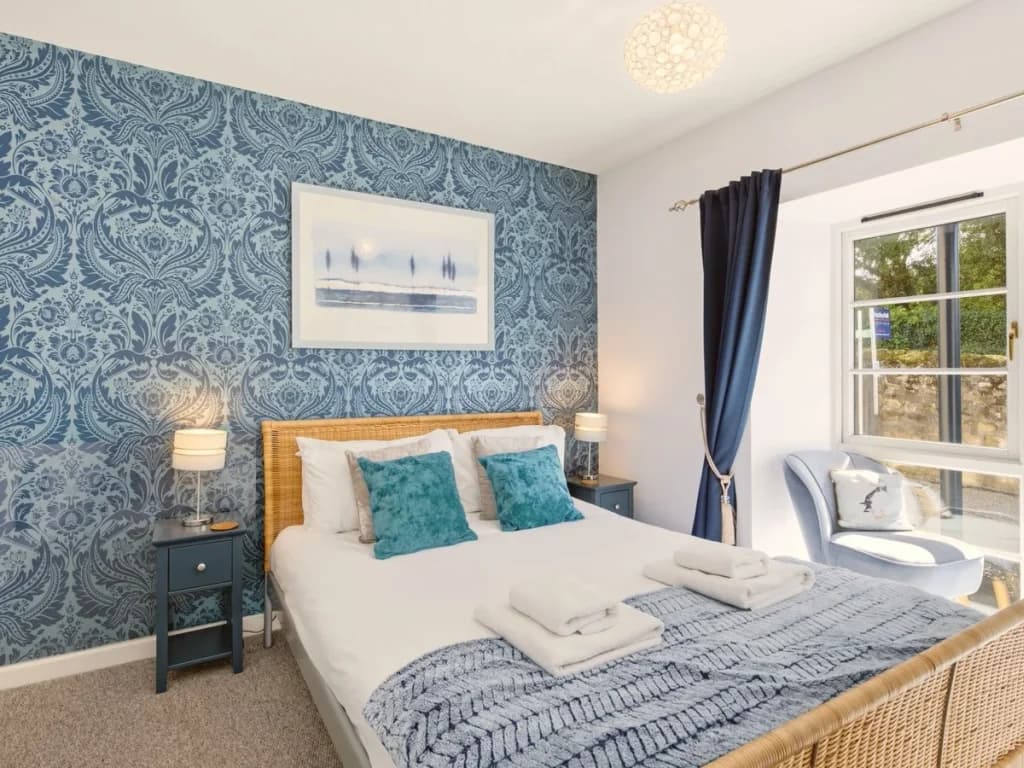 Bright king bedroom with blue feature wall