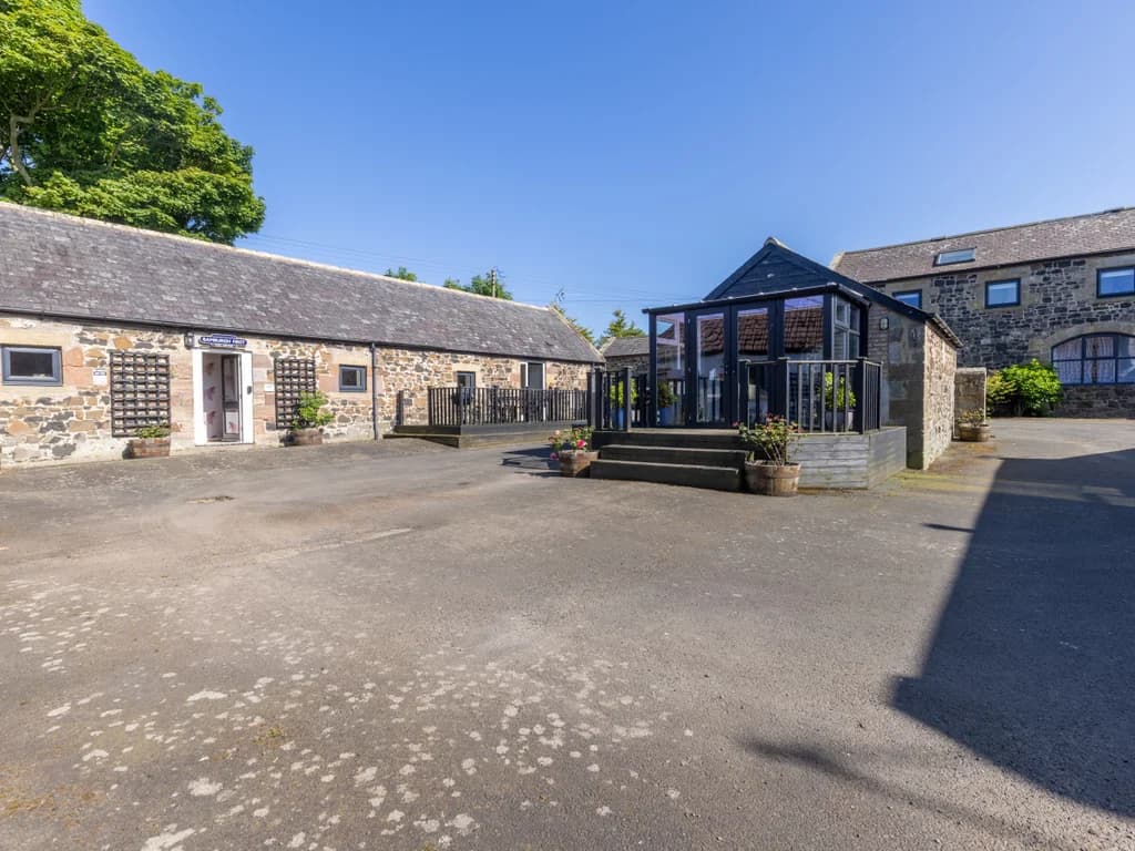 Central courtyard surrounded by converted stone farm buildings