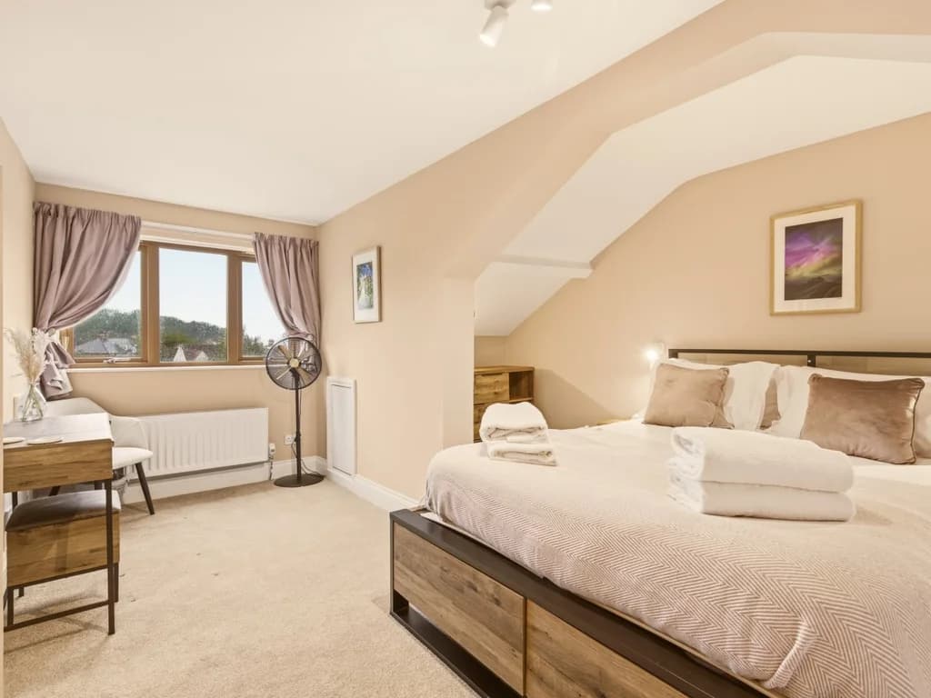 Spacious top-floor king bedroom with countryside views and en-suite.