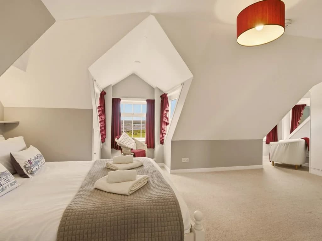 Characterful King bedroom with vaulted ceiling and beautiful Budle Bay views