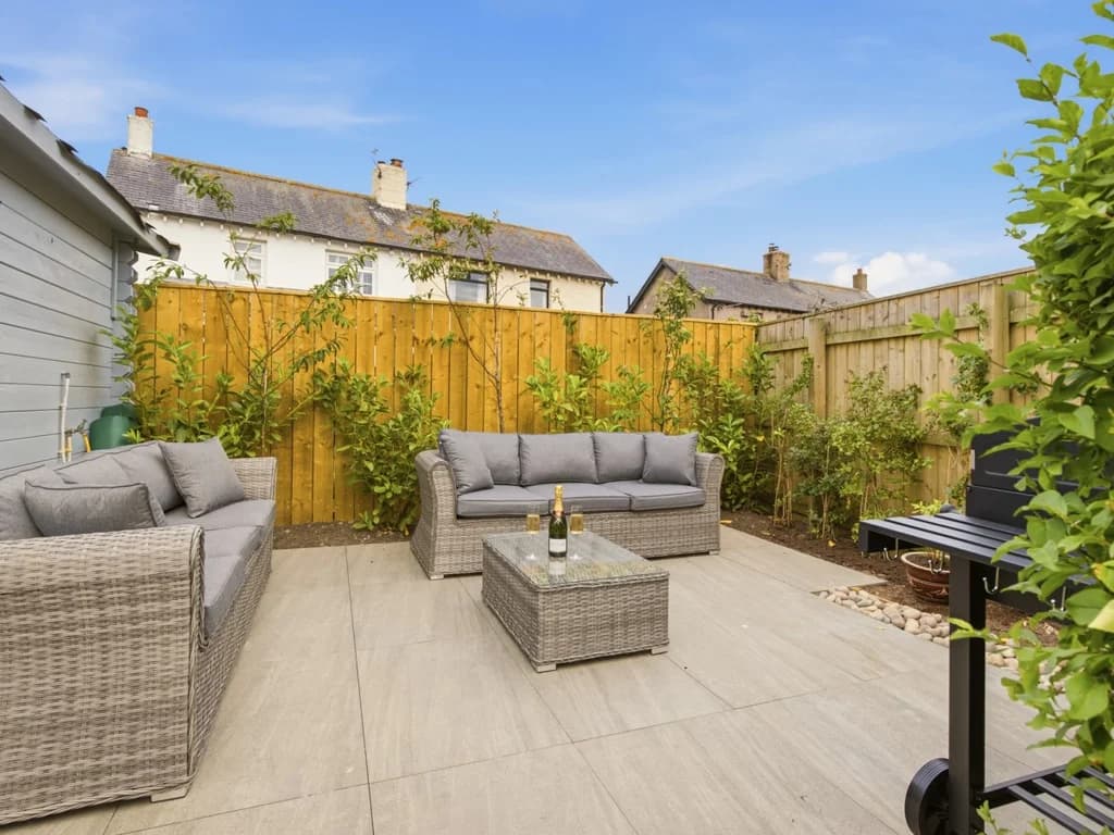 Private patio with comfortable outdoor seating and BBQ Grill