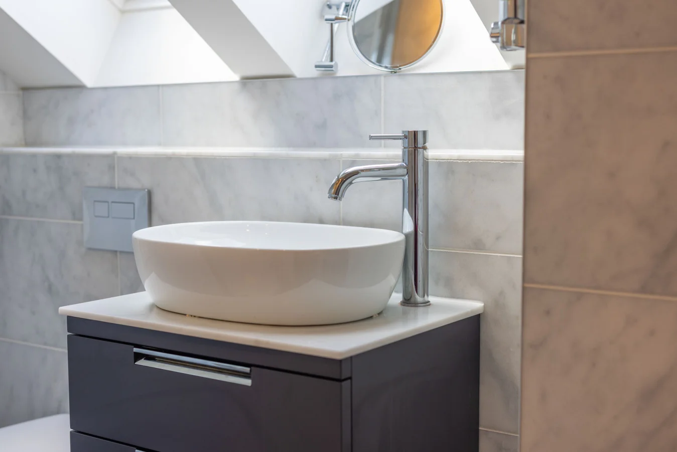Vessel basin on a dark vanity unit