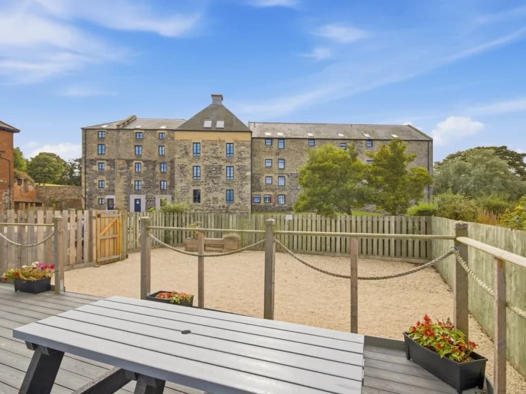 Outdoor seating area with views towards the historic Waren Mill building