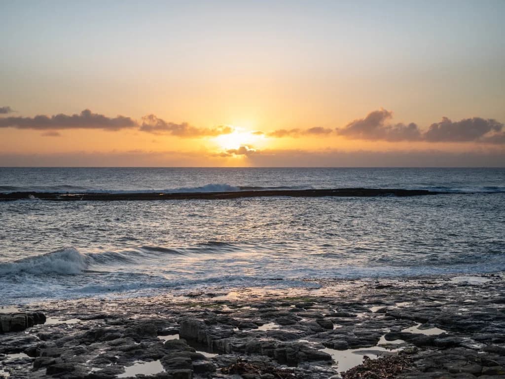 Stunning sunset over the North Sea, showcasing the dramatic beauty of the Northumberland coast.