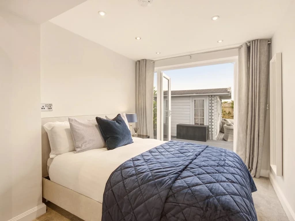 Stylish double bedroom with garden access for peaceful mornings by the coast