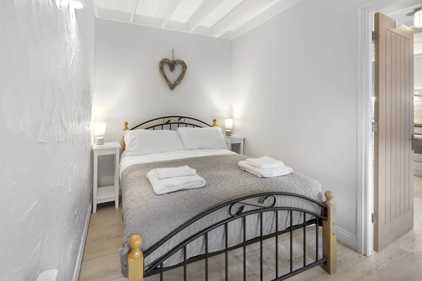 Peaceful sleeping area with bedside lighting and textured walls