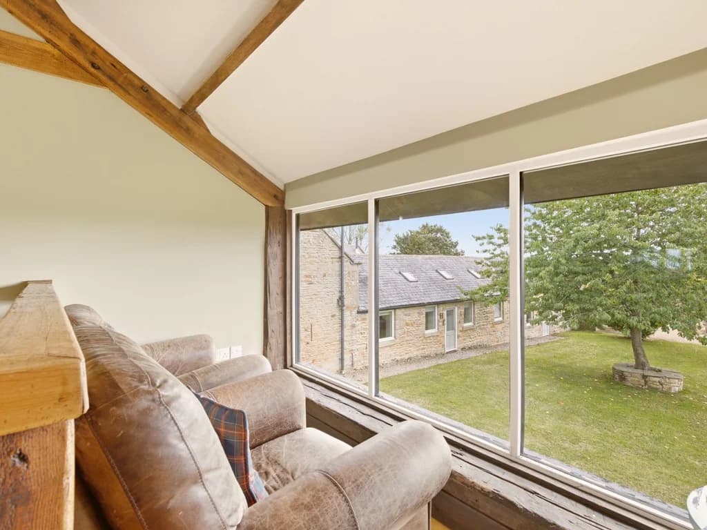 Upper seating area with large window overlooking the shared grounds
