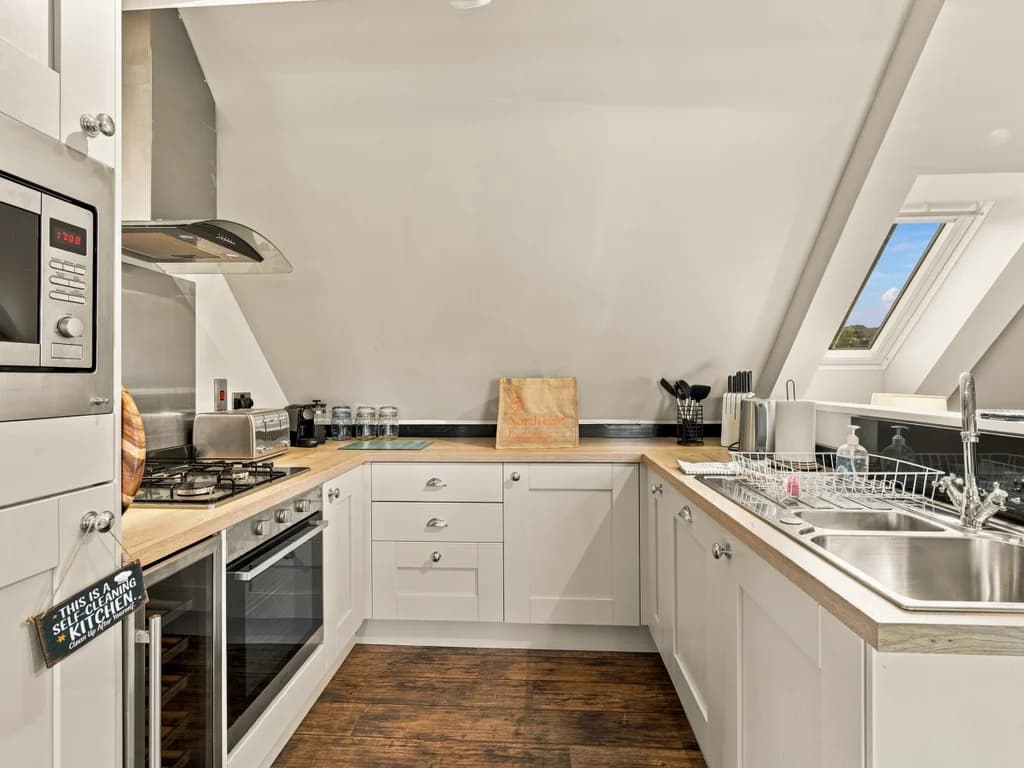Well-equipped kitchen with integrated appliances and breakfast bar.