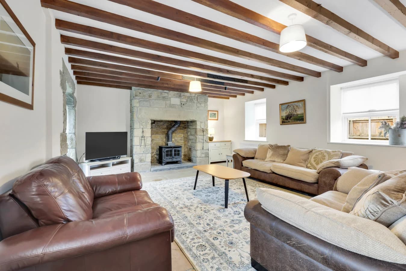 Comfortable living space with exposed beams and ample seating