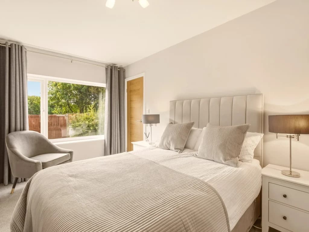 Bright and peaceful double bedroom with garden views and elegant furnishings