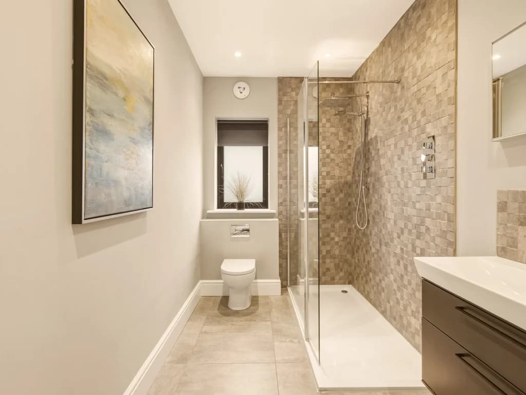 Family shower room with walk-in shower, stone-effect tiles and vanity unit