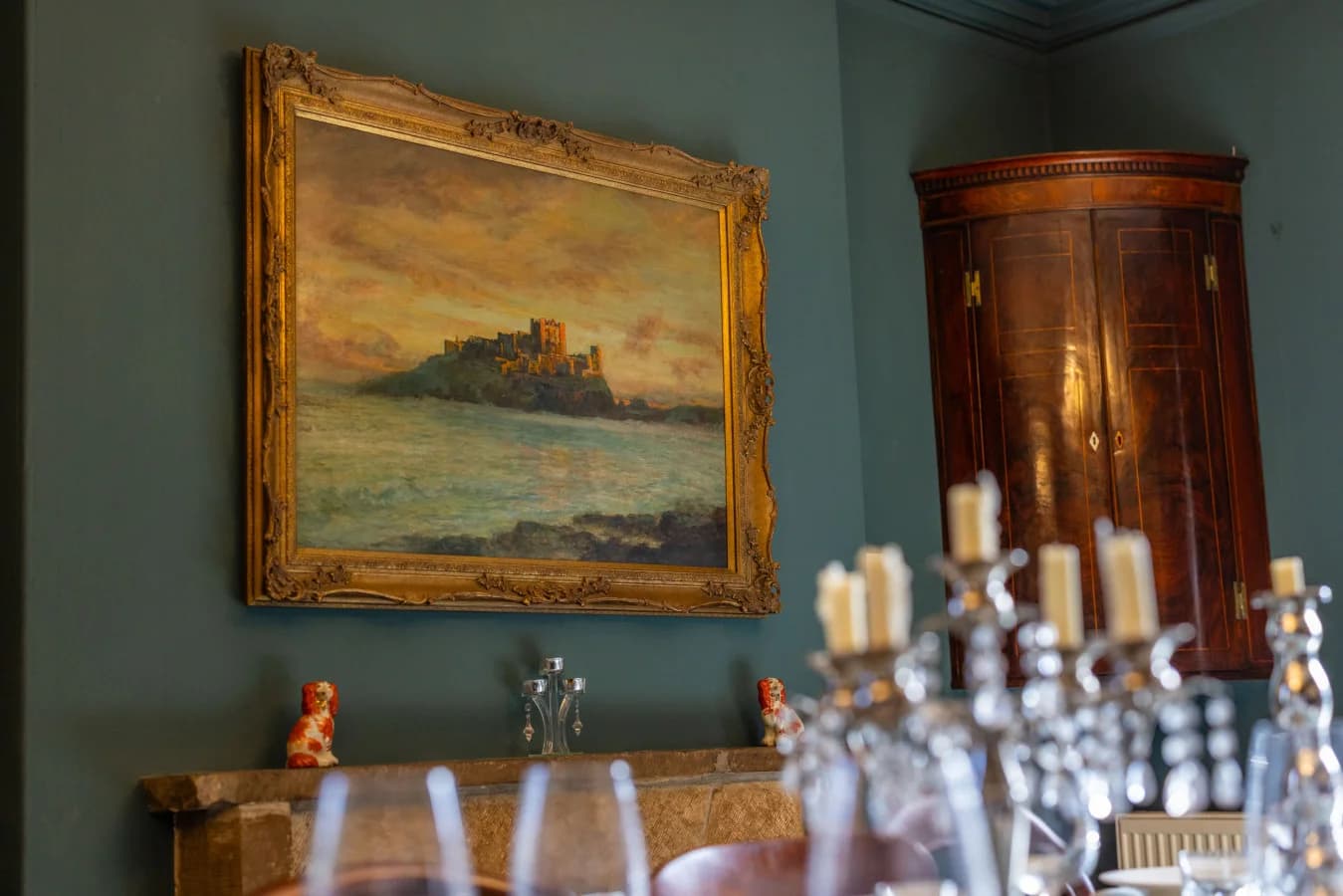 Framed coastal artwork and antique cabinet in the dining room