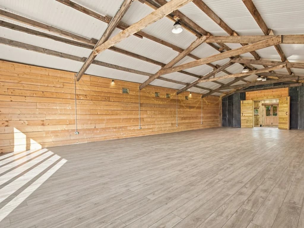 Open event space with timber walls, exposed beams and flexible layout