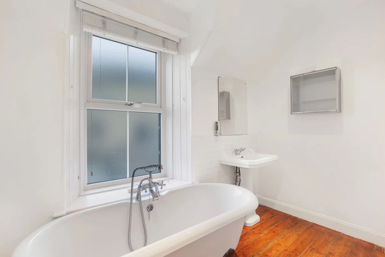 Family bathroom with freestanding bath and timber flooring