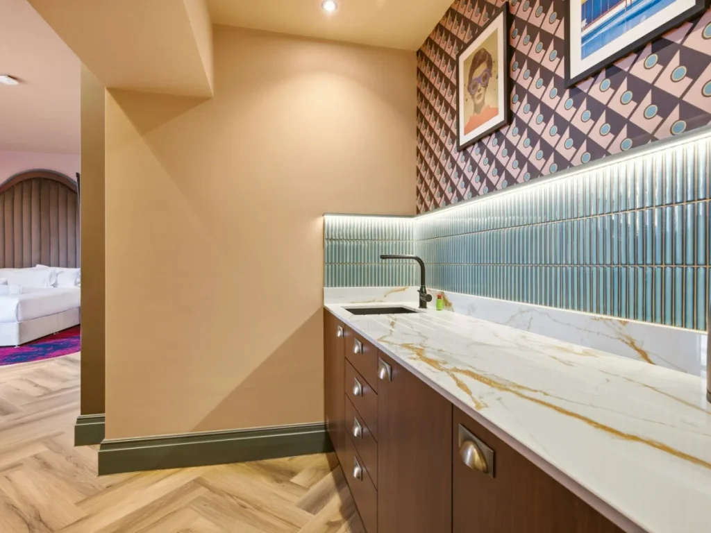 Kitchen worktop and sink with the open-plan sleeping area beyond.
