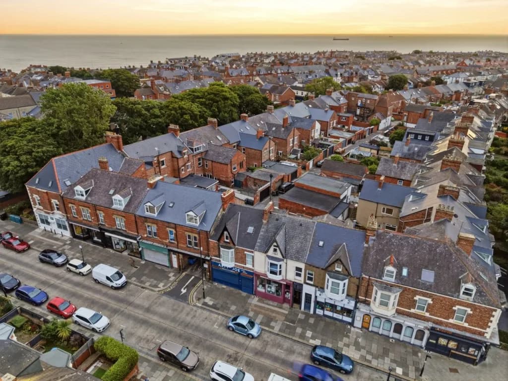 Elevated view of Station Road buildings with the coastline beyond