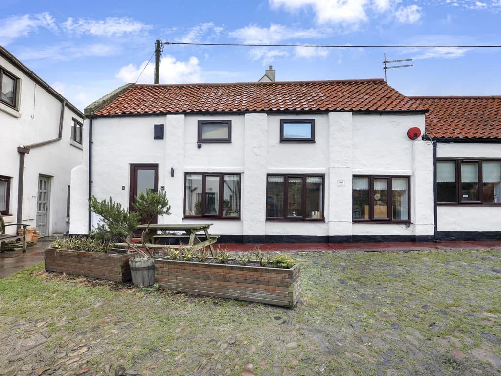 Courtyard view of the cottage just moments from Seahouses harbour