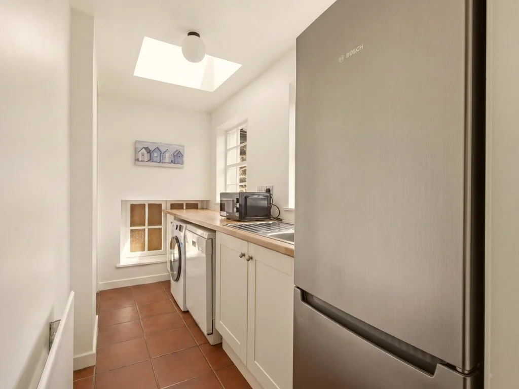 Practical utility room with laundry facilities and additional storage space
